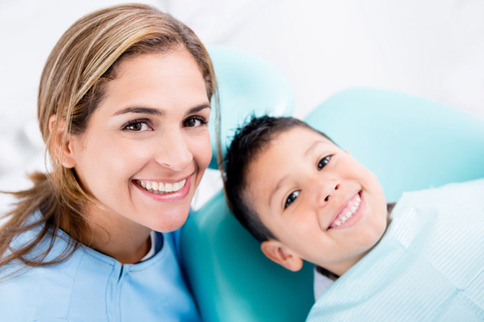 child with dental assistant